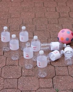 Indoor bowling using water bottles and a bouncy ball. 