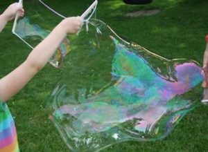 a child blowing a large bubble