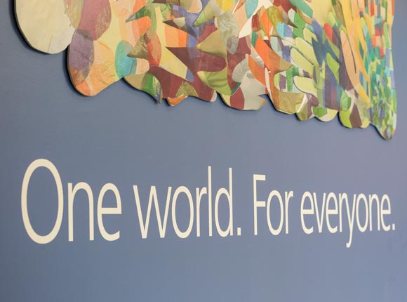 blue wall that reads "One world. For everyone." in white text