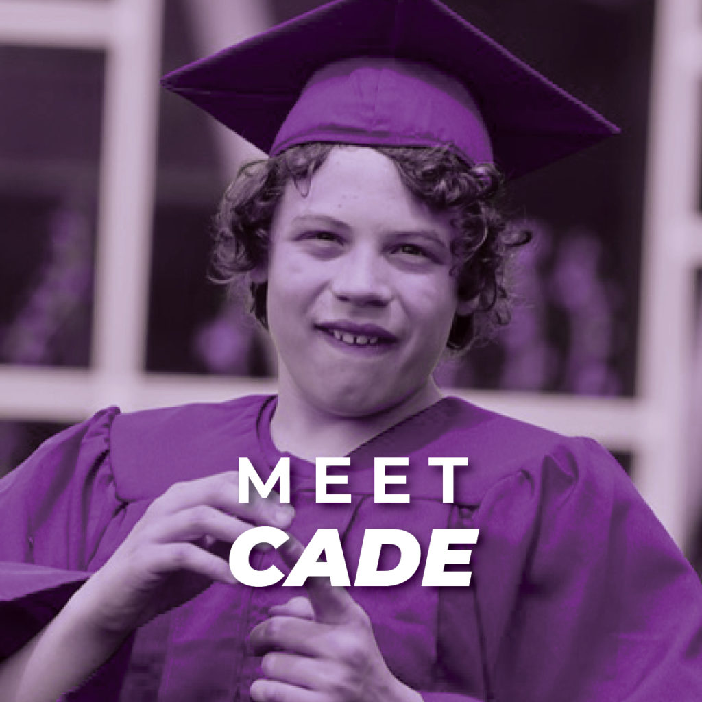 Cade; a young boy with curly hair wearing a graduation cap and robe