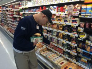 Bancroft adult employment Shop Rite worker stocking cheeses in dairy section.