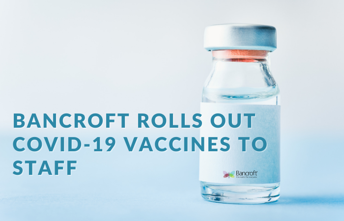 Graphic that reads "Bancroft Rolls Out COVID-19 Vaccines to Staff" with a bottle in the background