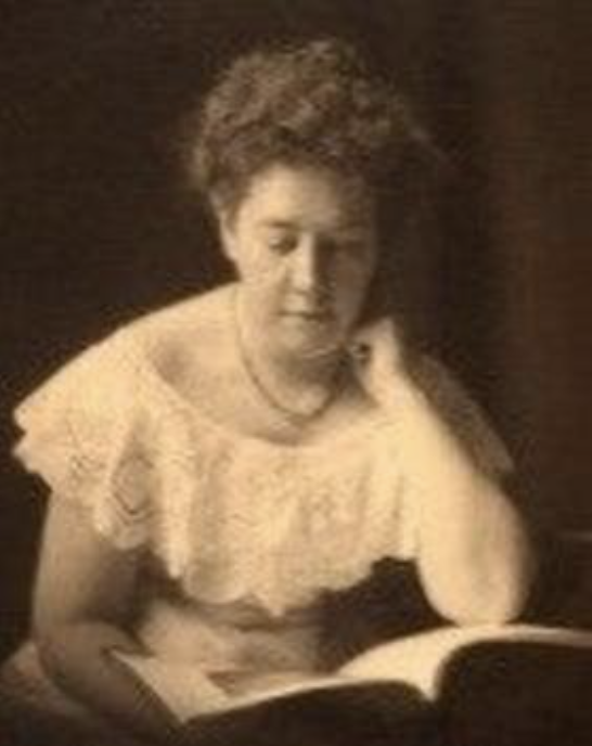 Black and white photo of Margaret Bancroft, a light-skinned woman wearing a lacy dress and reading a book