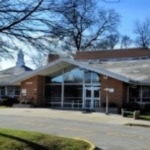 brick Bancroft building with large windows with white panes