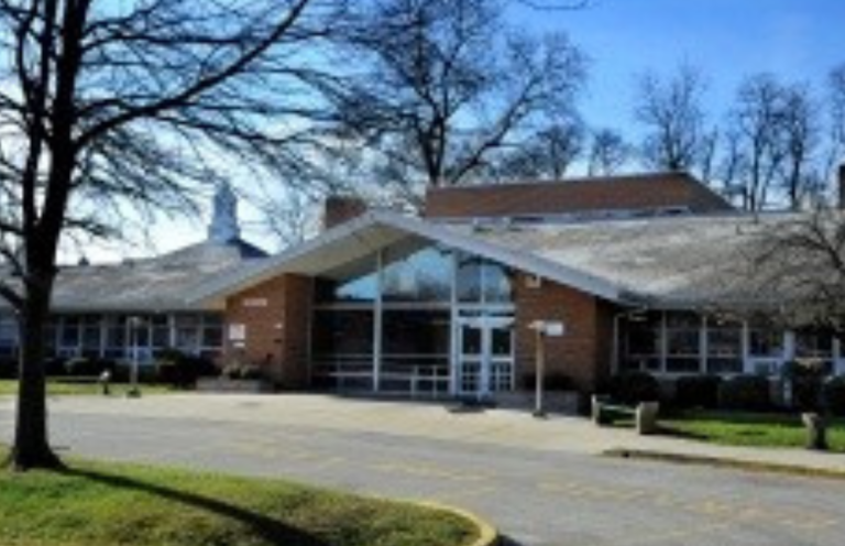 brick Bancroft building with large windows with white panes