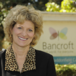 Toni Pergolin, Bancroft's President and CEO, a light-skinned woman with curly blonde hair wearing a black and leopard print top