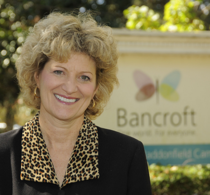 Toni Pergolin, Bancroft's President and CEO, a light-skinned woman with curly blonde hair wearing a black and leopard print top