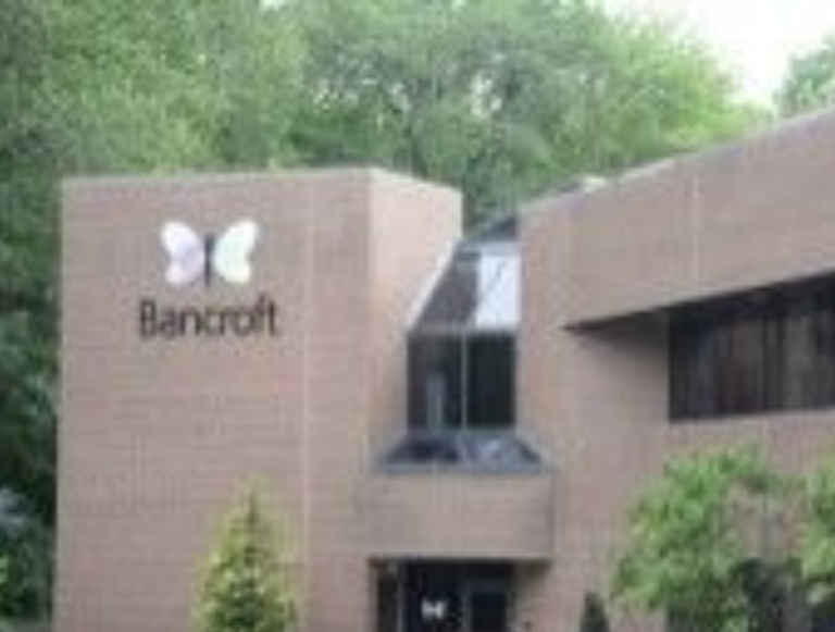 Bancroft headquarters; a brown two-story building with a large Bancroft logo