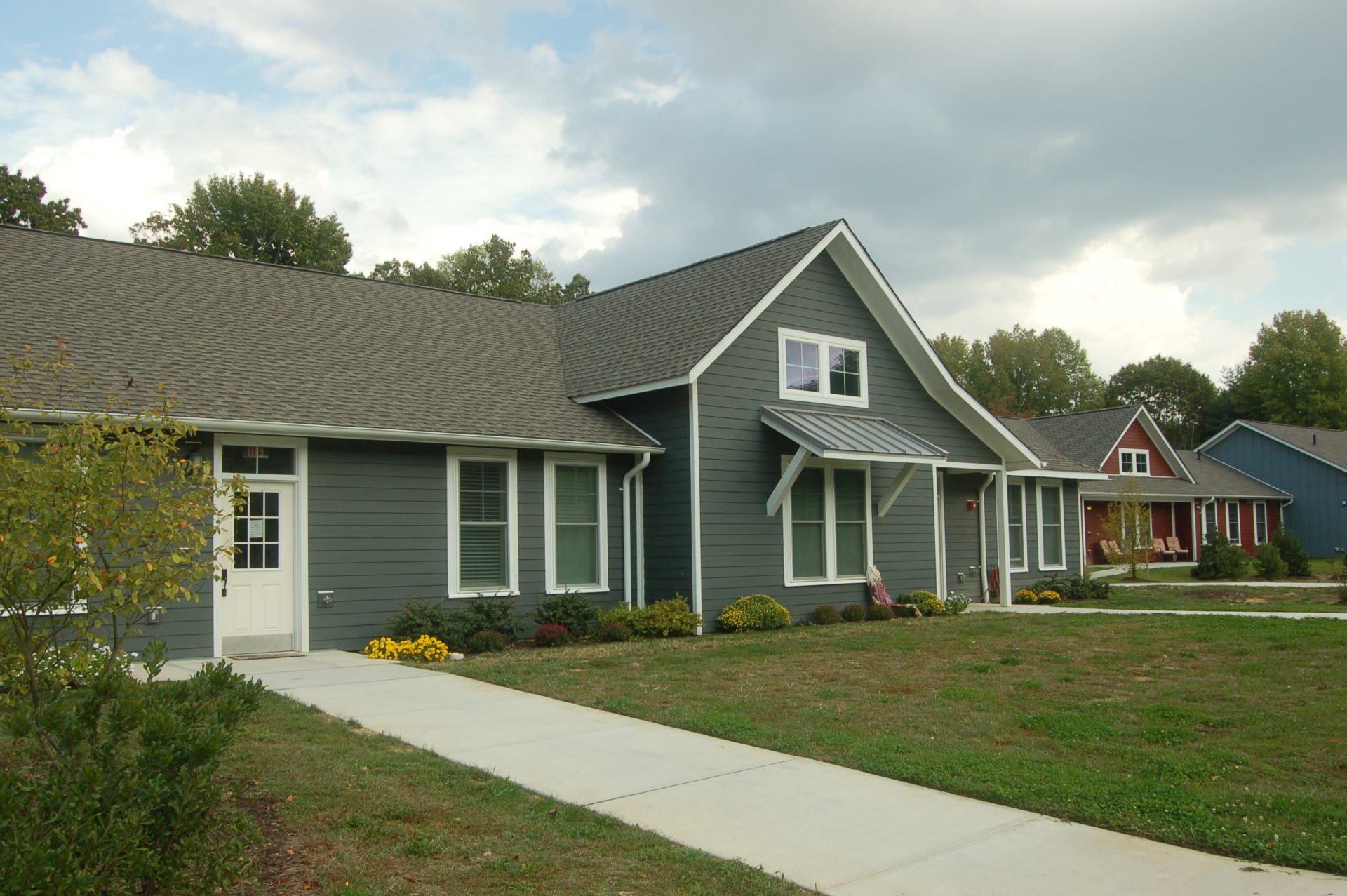 gray home with a gray roof and white door and trimmings