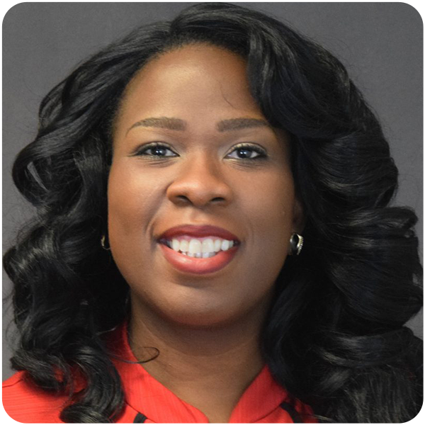 Dioana Gayle, a woman with dark black curly hair and red lipstick wearing a red blouse, smiling