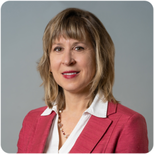 Bancroft's Chief Clinical Officer Karen Lindgren's headshot while smiling in a pink blazer