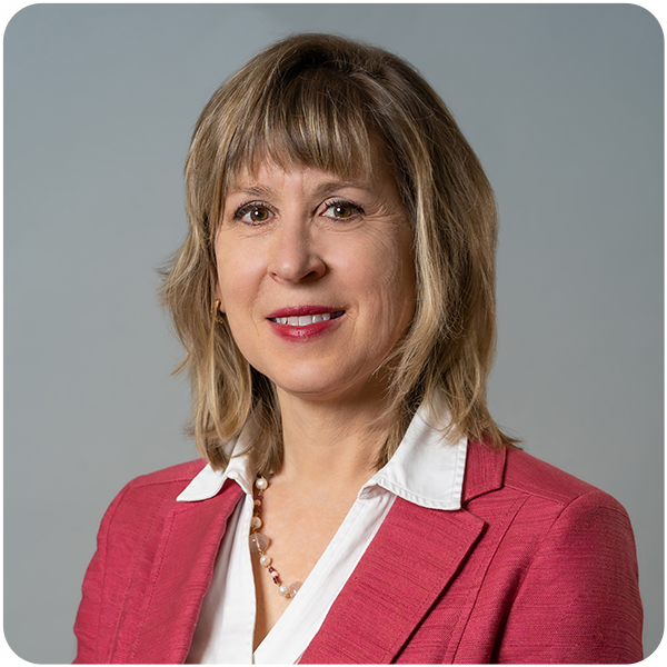 Bancroft's Chief Clinical Officer Karen Lindgren's headshot while smiling in a pink blazer