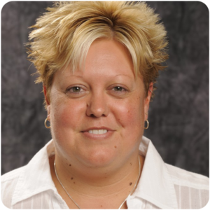 Michelle Habingreither, a light-skinned woman with blonde hair wearing a white button up shirt, smiling