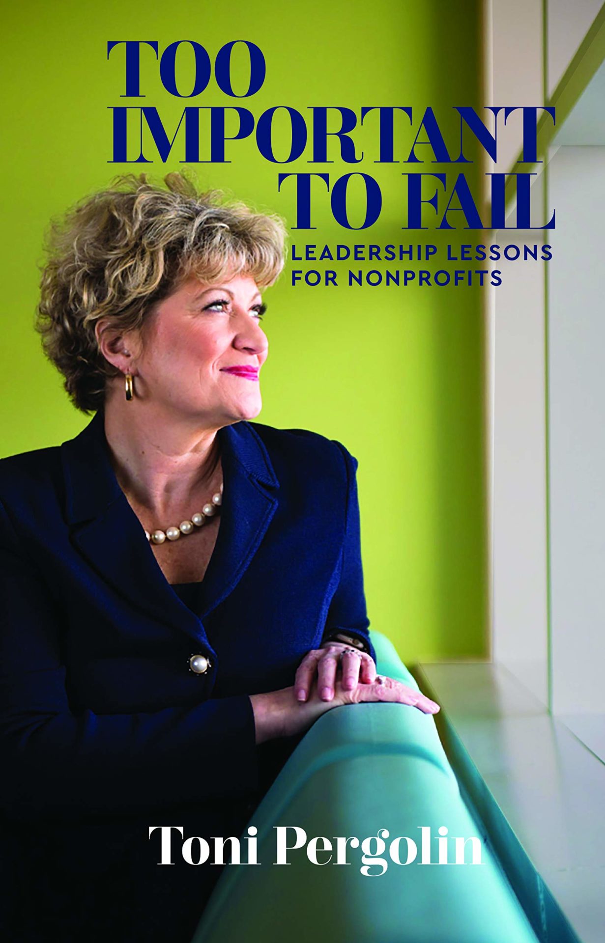 Toni Pergolin's "Too Important to Fail" book cover that has the cover title in blue font and a picture of Toni sitting by a window on a blue couch in a green room