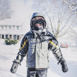 Little boy all bundled up outside in the snow