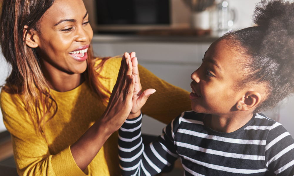 Mom high fives daughter