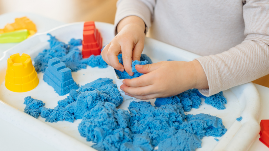 Little boy playing with sensory bin