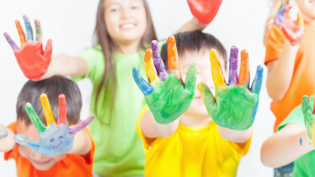 Kids holding up their hands with washable paint on them