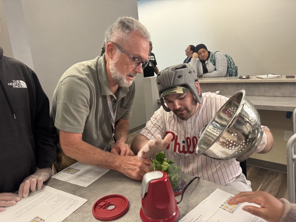 Participant and Robert Trombley, Bancroft RD, make broccoli cheddar bites snack