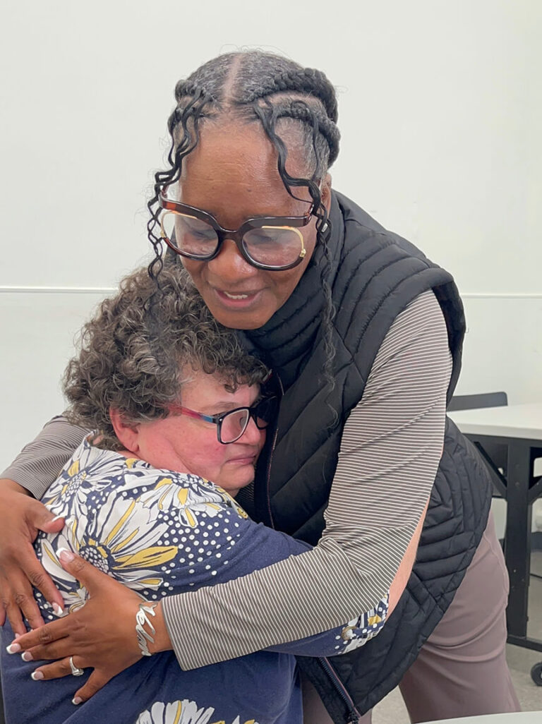 Velma Green embraces female individual at Bancroft Day program