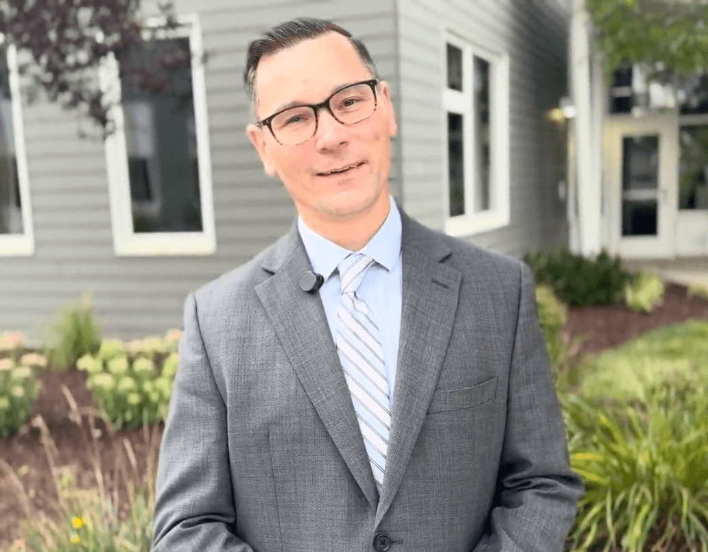 Brian Hancock stands outside of The Bancroft School