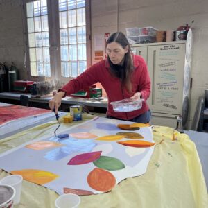 Linda Miller paints mural details