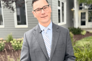 Brian Hancock stands outside of The Bancroft School