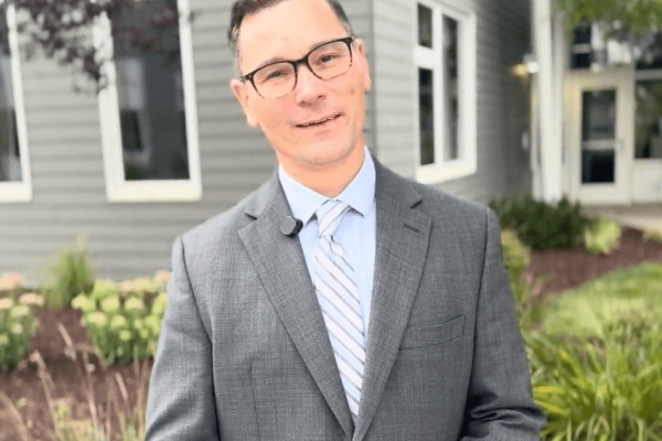 Brian Hancock stands outside of The Bancroft School