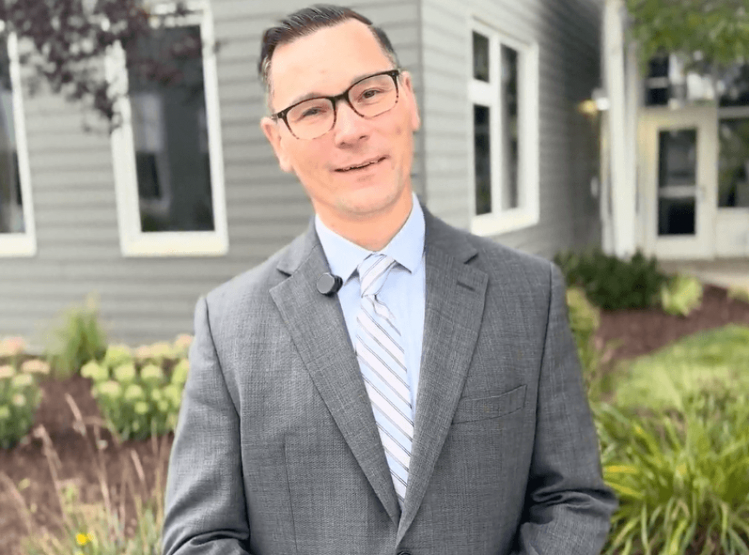 Brian Hancock stands outside of The Bancroft School