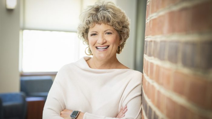 Toni Pergolin, CEO of Bancroft, leans against a brick wall