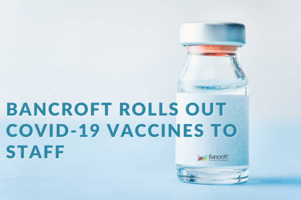 Graphic that reads "Bancroft Rolls Out COVID-19 Vaccines to Staff" with a bottle in the background