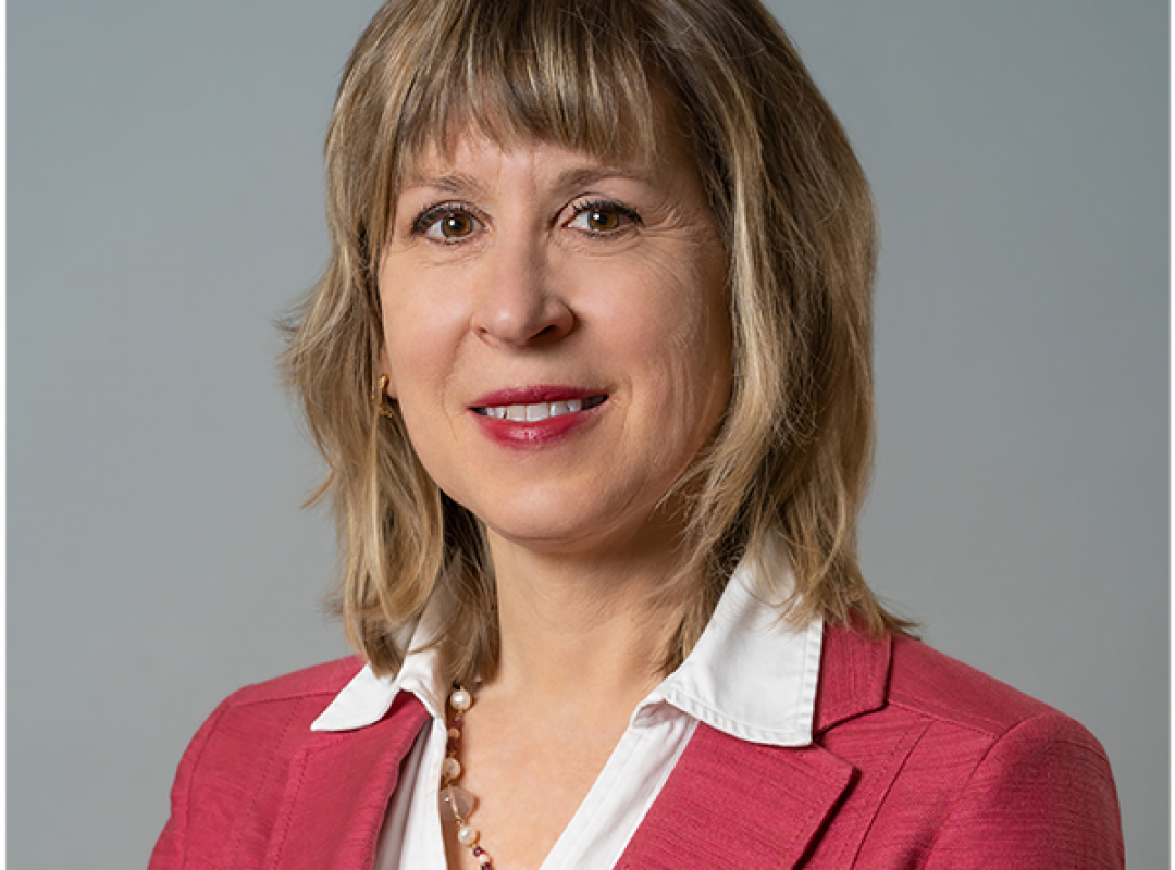 Bancroft's Chief Clinical Officer Karen Lindgren's headshot while smiling in a pink blazer