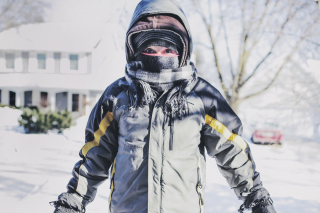 Little boy all bundled up outside in the snow