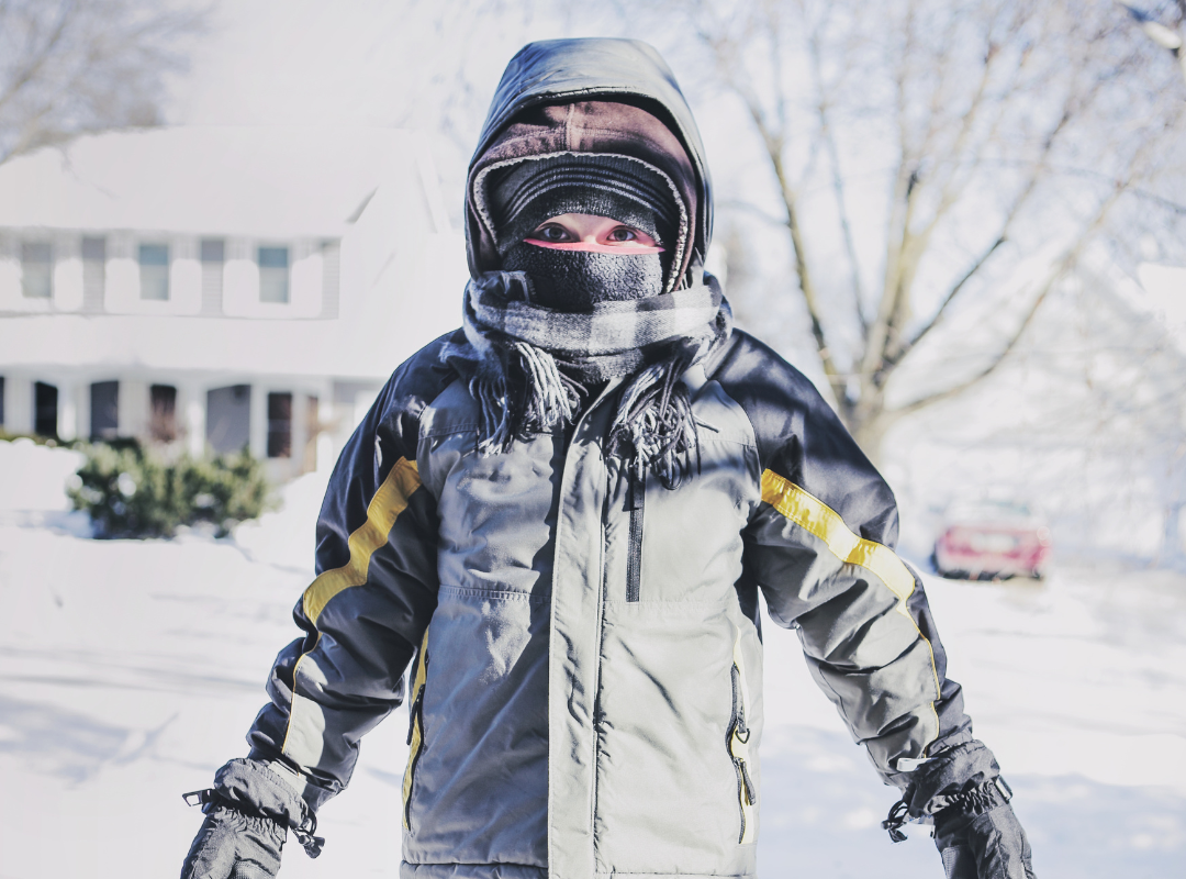 Little boy all bundled up outside in the snow