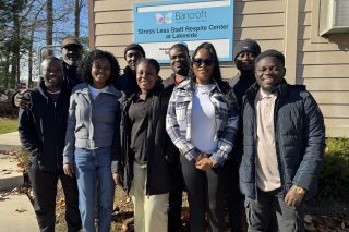 picture of the first five international team members at Bancroft with other staff at Lakeside Program