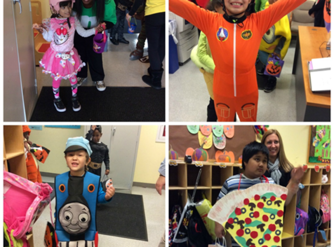 four children wearing their halloween costumes, a little girl as Hello Kitty, a little boy as Thomas the Tank Engine, a little girl as a space pilot, and a boy as a piece of pizza